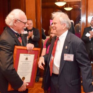 man giving other man certificate