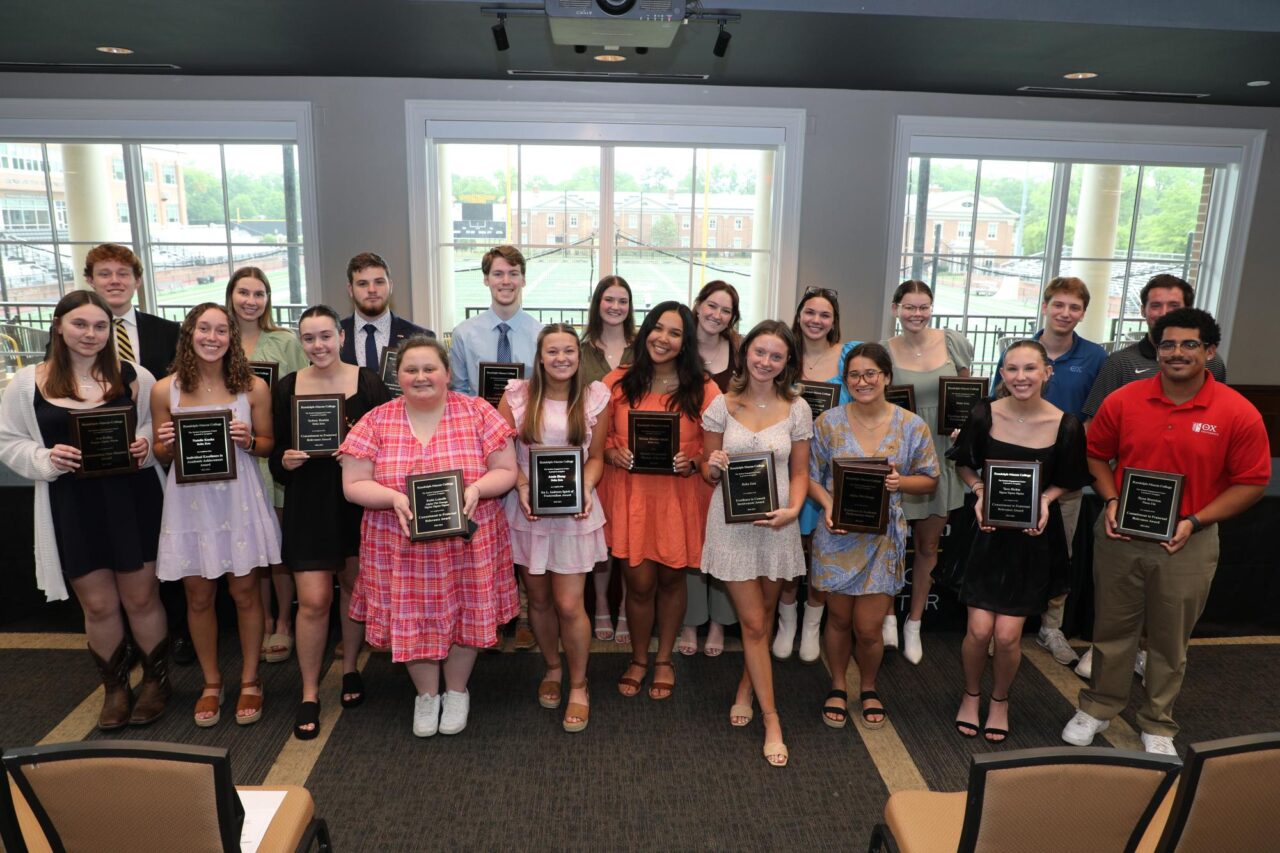 Group photo of award recipients and plaques