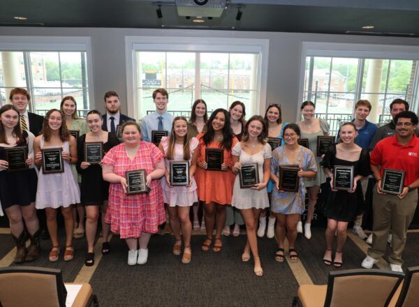 Group photo of award recipients and plaques
