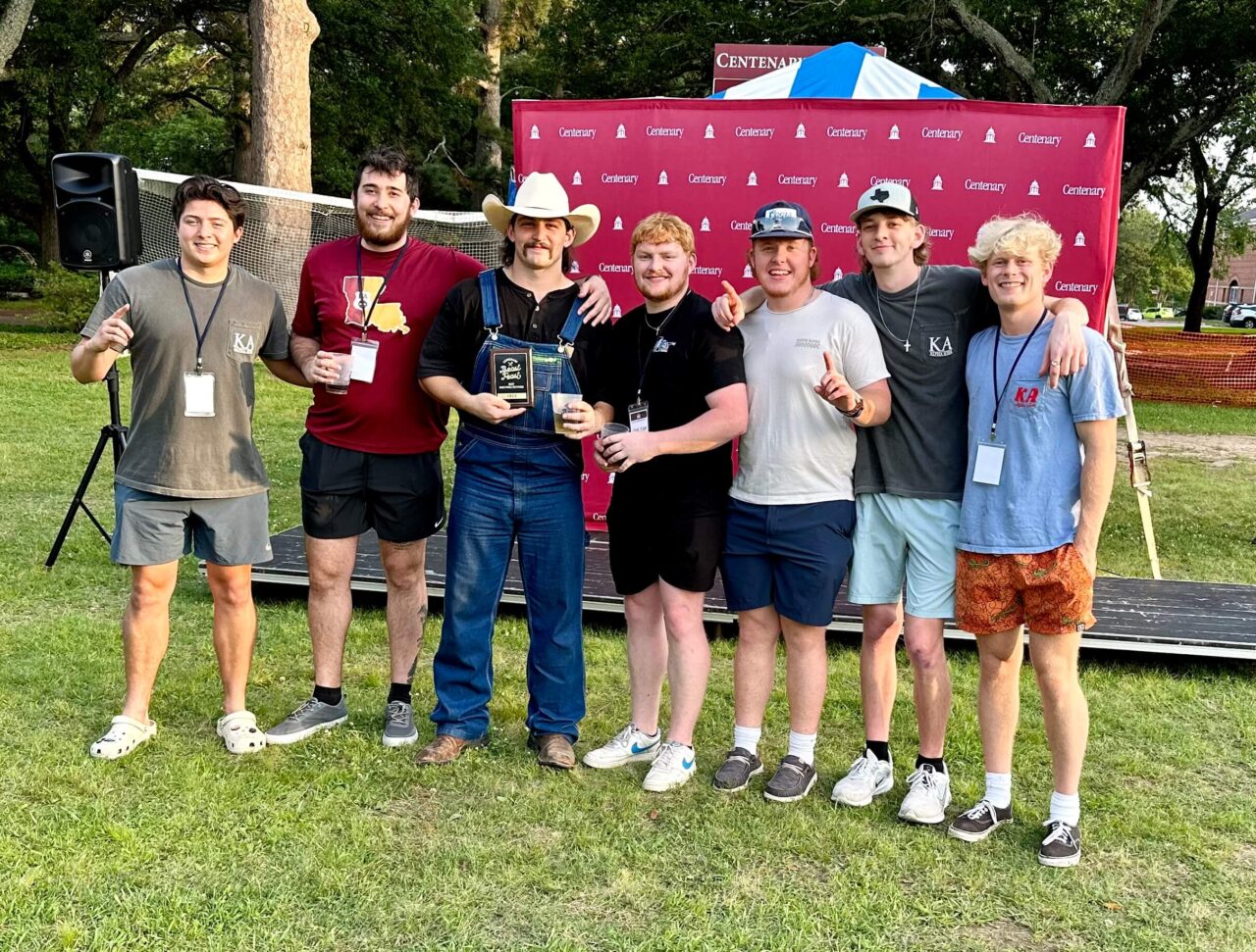 fraternity brothers standing in front of grill