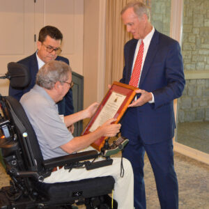McCormick receiving award from Malcolm Liles, Member of the Order's Executive Council