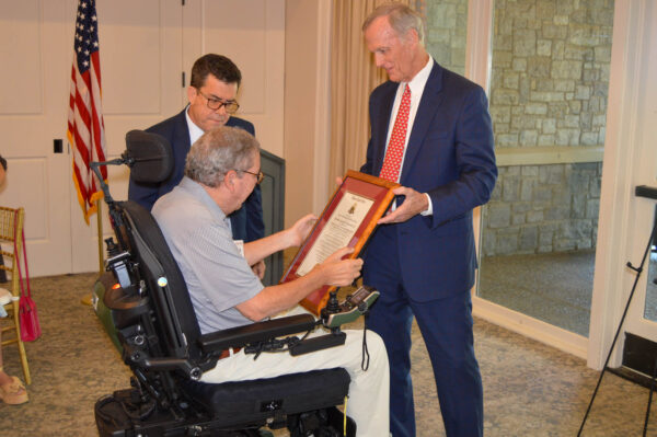 McCormick receiving award from Malcolm Liles, Member of the Order's Executive Council