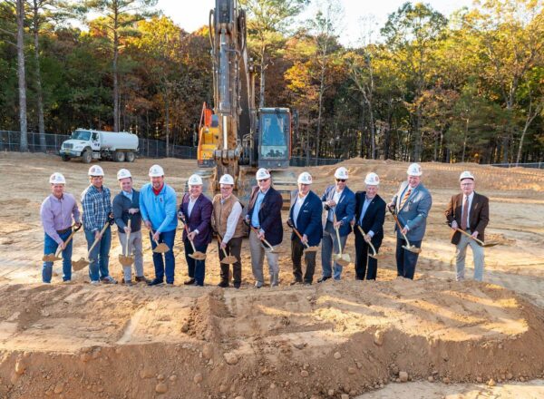 group of men holding shovels and dirt