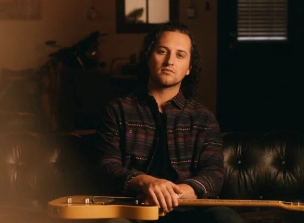 Reid with guitar on lap